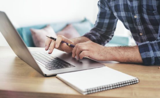 person typing on laptop
