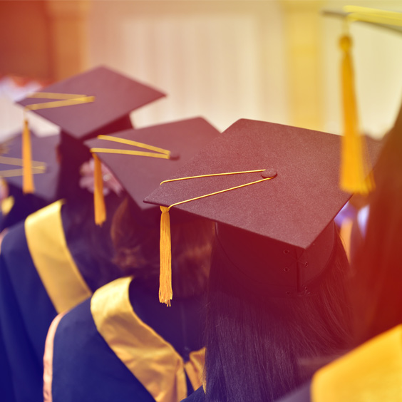 Photo of students wearing graduation caps.