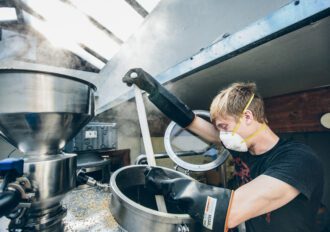 Man brewing beer in a commercial brewing operation.