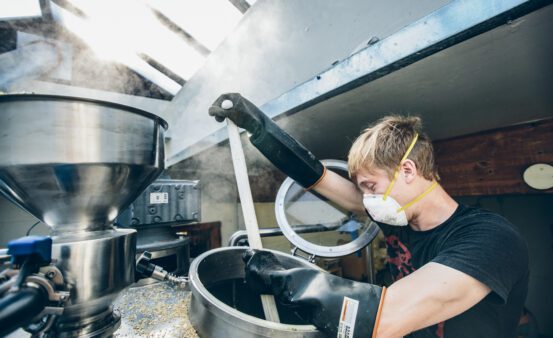 Man brewing beer in a commercial brewing operation.