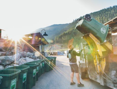 Missoula Compost company employee emptying bins into a truck.