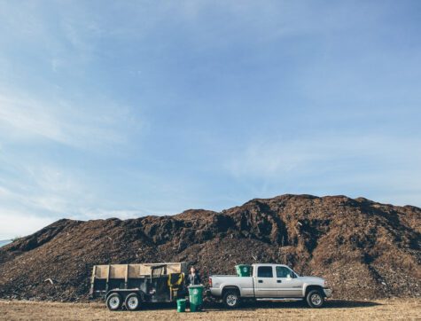 Missoula Compost company employee emptying bins into a truck.