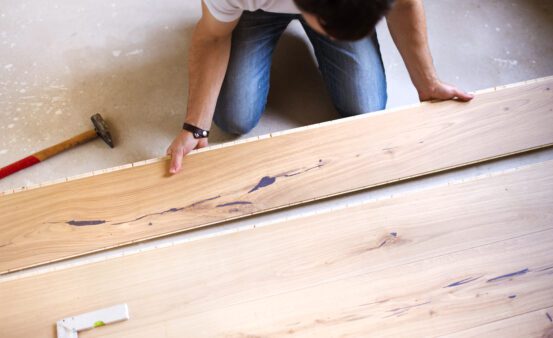 Man installing hardwood floor.