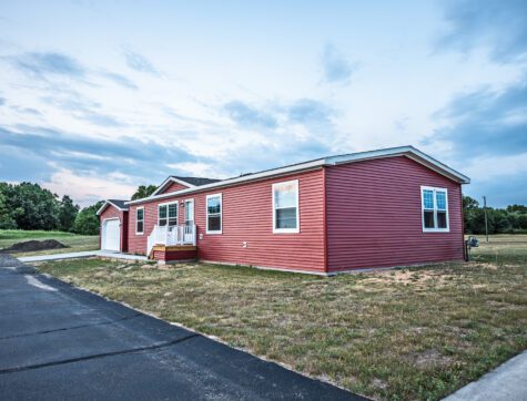 New manufactured home in a new community. The window on the far right on the front shows a reflection of the sunset at the top.