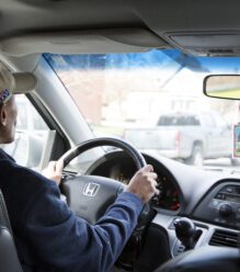 Man behind the wheel driving his new car.