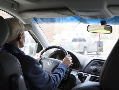 Man behind the wheel driving his new car.