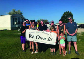 Group of people celebrate turning their mobile home park in to a Resident Owned Community (ROC).