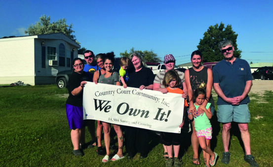 Group of people celebrate turning their mobile home park in to a Resident Owned Community (ROC).