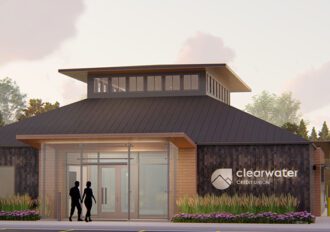 Image of the Brooks St. Branch location with two people holding hands walking towards the entrance