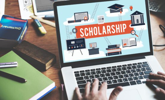 Laptop with Scholarship graphic on the screen.