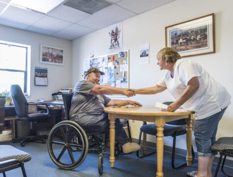 Opportunity Resources client in wheel chair meeting with staff member.