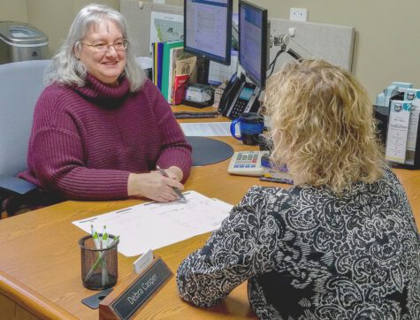 Clearwater staff person talks to a member about financial education at a Missoula member event in Missoula, MT.