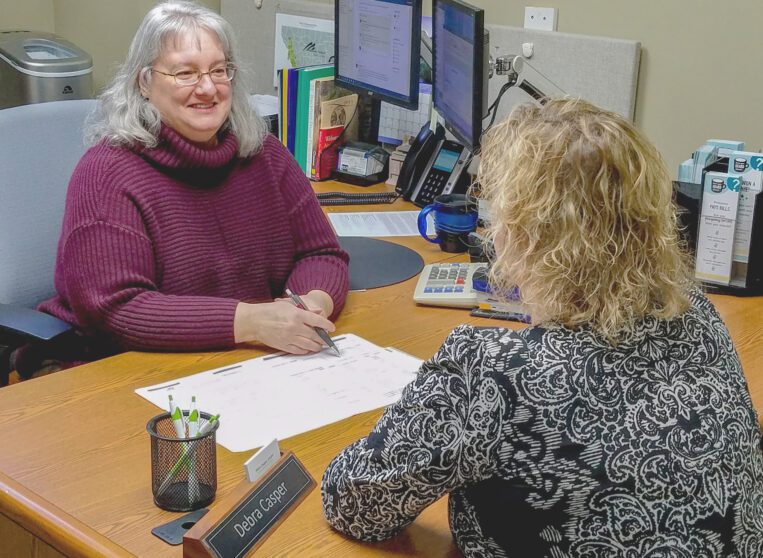 Clearwater staff person talks to a member about financial education at a Missoula member event in Missoula, MT.