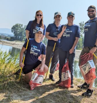 Group photo of five Clearwater Credit Union employees volunteering during the 2024 Bitterroot River Clean Up.