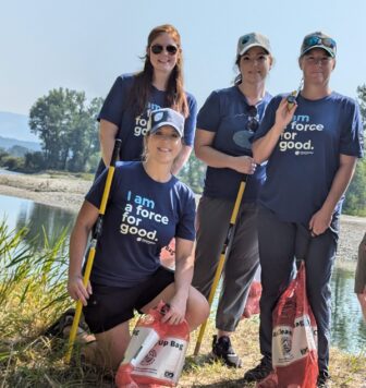 Group photo of five Clearwater Credit Union employees volunteering during the 2024 Bitterroot River Clean Up.