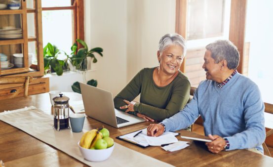 Finance, laptop and happy senior couple with bills, paperwork and documents for life insurance. Retirement, pension and elderly man and woman on computer for mortgage payment, investment and budget.