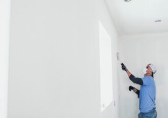 Man painting the inside of a house.