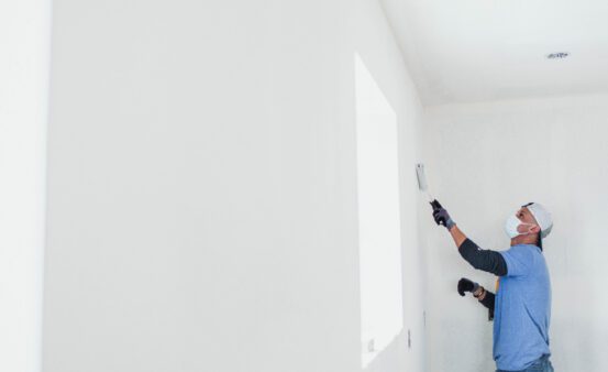 Man painting the inside of a house.