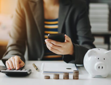 Business accountant working on desk using mobile phone and calculator to calculate budget concept finance and accounting