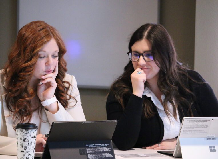 Two women looking at a computer.
