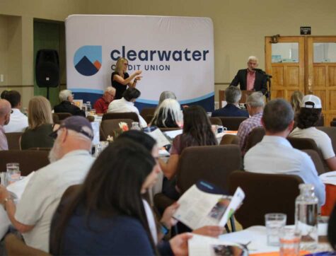 A group of people listening to a man speak