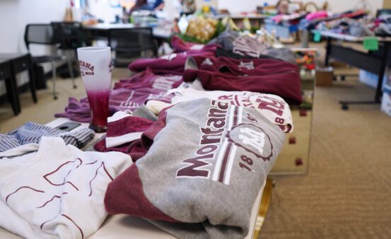 A table of maroon and gray University of Montana clothing.